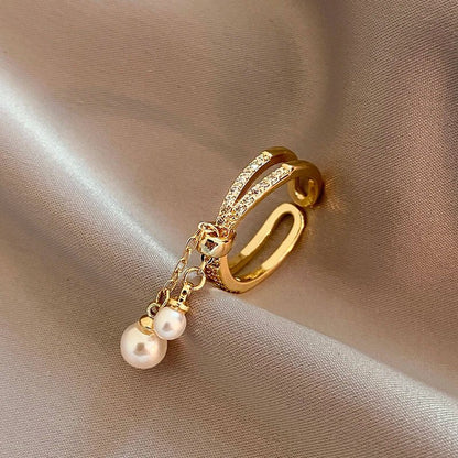 Bague pendentif anneaux croisés diamants perles