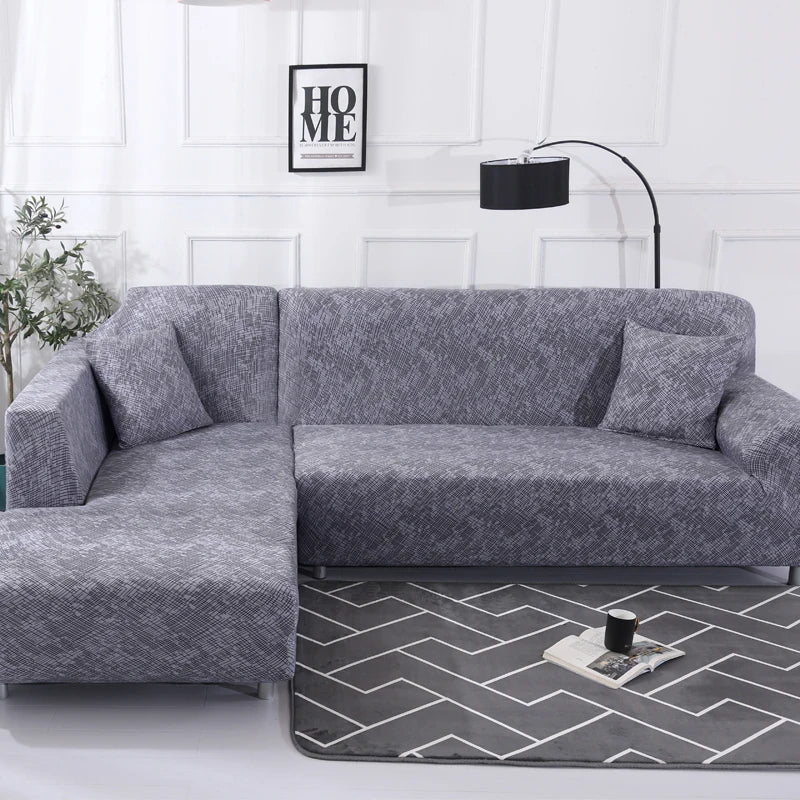 Housse Canapé d'Angle Elastique et Moderne dans un salon sur fond de mur blanc avec une lampe noire et un tableau